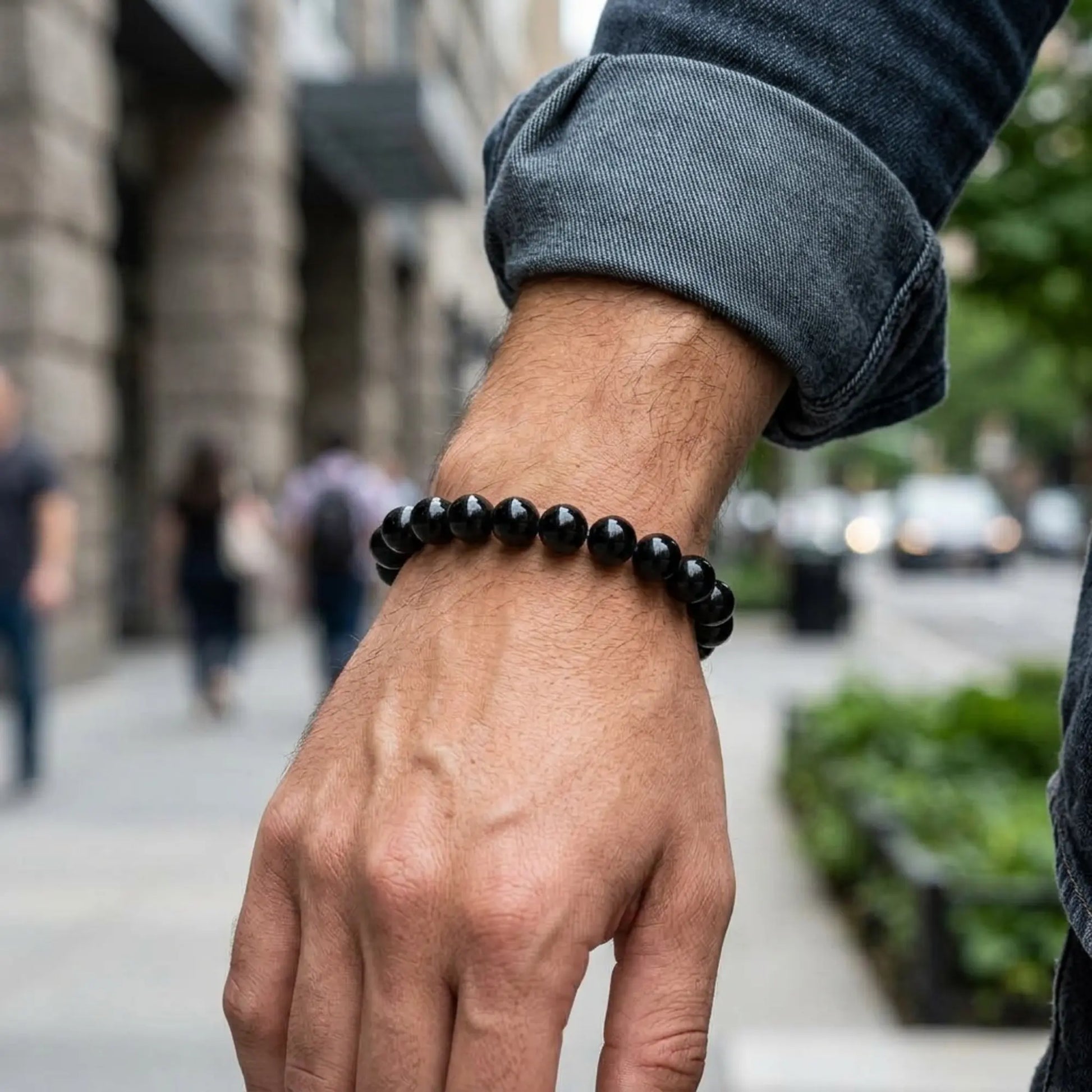 Bracelet Nox en obsidienne noire porté au poignet dans un environnement urbain